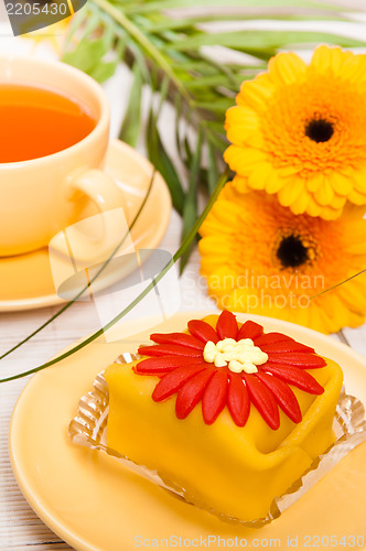 Image of tea with cake and gerberas flowers