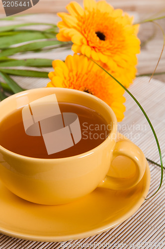 Image of tea with cake and gerberas flowers