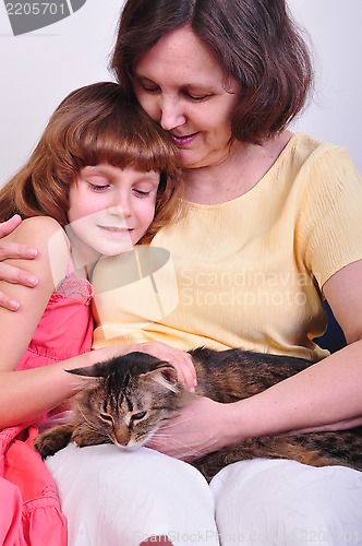 Image of grandmother and granddaughter with their cat