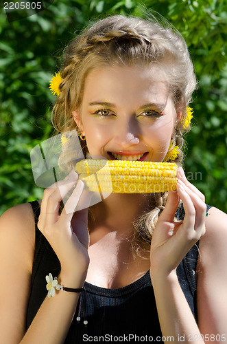 Image of woman eating corn-cob