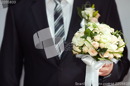 Image of Groom with a bouquet