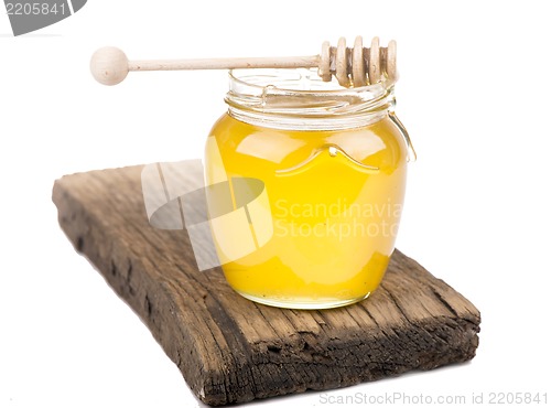 Image of Honey in bank on wooden boards