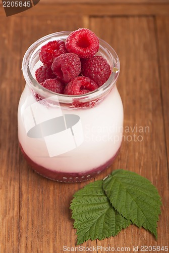 Image of White yogurt in a glass jar with raspberry