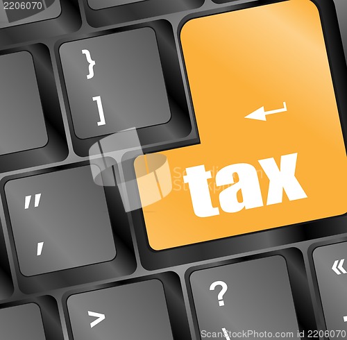 Image of tax word on laptop keyboard key, business concept