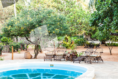 Image of Chairs on swimming pool border