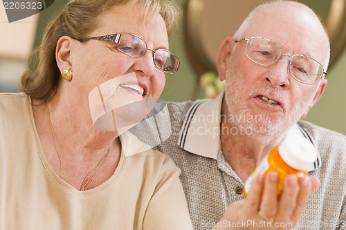 Image of Senior Couple Reading Medicine Bottle