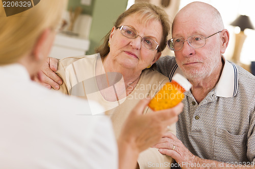 Image of Doctor or Nurse Explaining Prescription Medicine to Senior Coupl