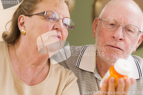 Image of Senior Couple Reading Medicine Bottle