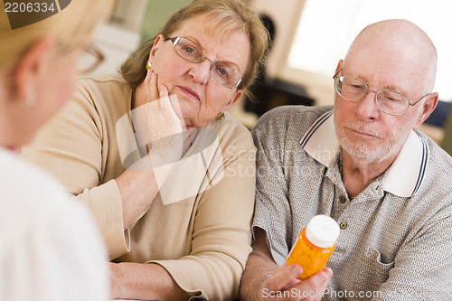Image of Doctor or Nurse Explaining Prescription Medicine to Senior Coupl