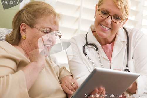 Image of Doctor or Nurse Talking to Senior Woman with Touch Pad