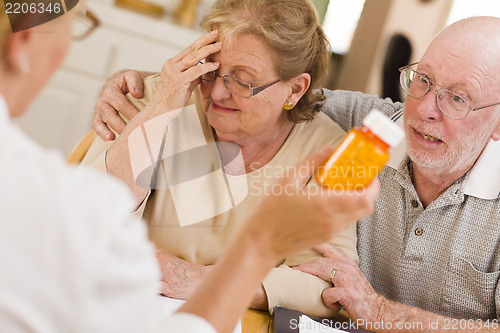 Image of Doctor or Nurse Explaining Prescription Medicine to Senior Coupl