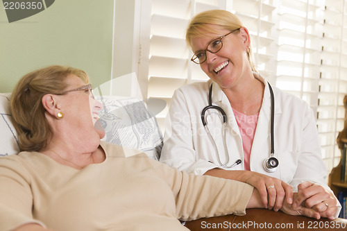 Image of Doctor or Nurse Talking to Sitting Senior Woman