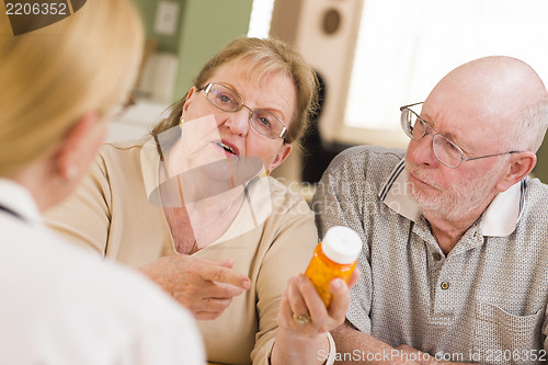 Image of Doctor or Nurse Explaining Prescription Medicine to Senior Coupl