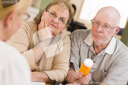 Image of Doctor or Nurse Explaining Prescription Medicine to Senior Coupl