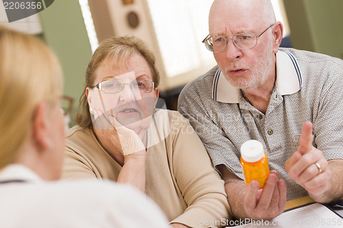 Image of Doctor or Nurse Explaining Prescription Medicine to Senior Coupl