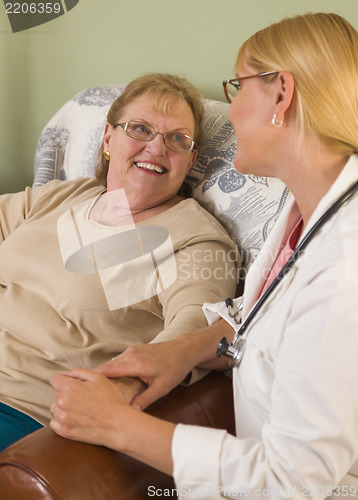 Image of Doctor or Nurse Talking to Sitting Senior Woman