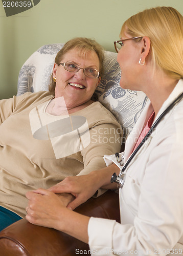 Image of Doctor or Nurse Talking to Sitting Senior Woman
