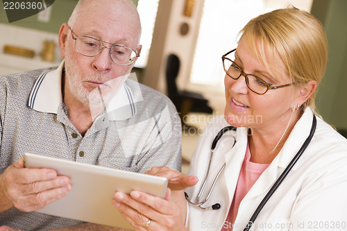 Image of Doctor or Nurse Talking to Senior Man with Touch Pad