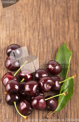 Image of Red, ripe, juicy cherries on wooden boards