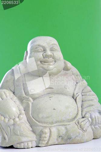 Image of A buddha figurine against a green background