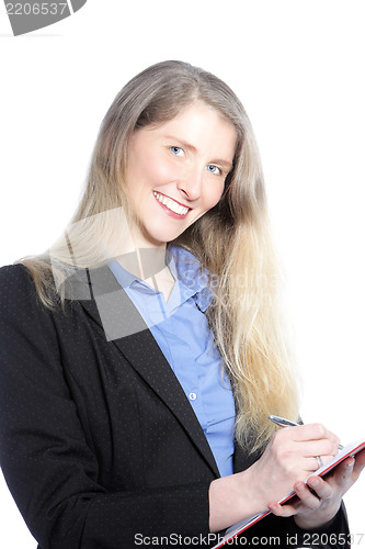 Image of Smiling businesswoman writing notes