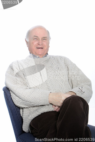 Image of Happy senior man relaxing in a chair