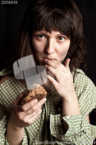 Image of beggar woman eating bread 