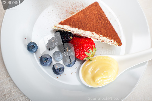 Image of tiramisu dessert with berries and cream