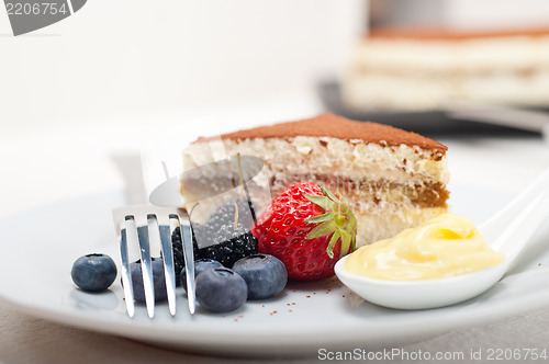 Image of tiramisu dessert with berries and cream