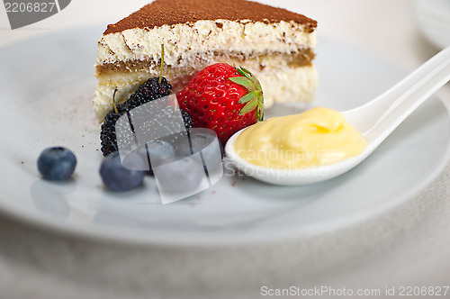 Image of tiramisu dessert with berries and cream