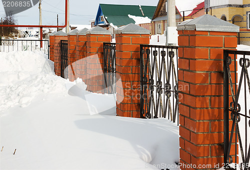 Image of Red fence covered with snow