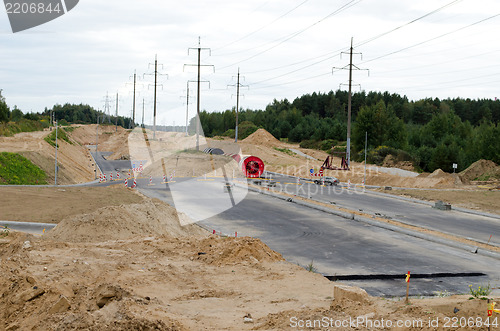 Image of cars roundabout highway construct electricity pole 