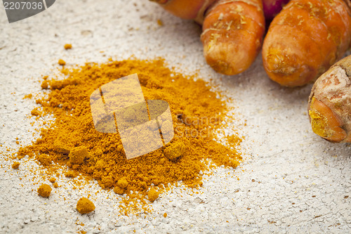 Image of turmeric powder  and root