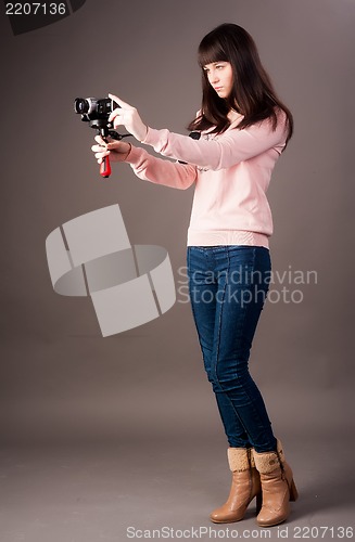 Image of young woman with video camera