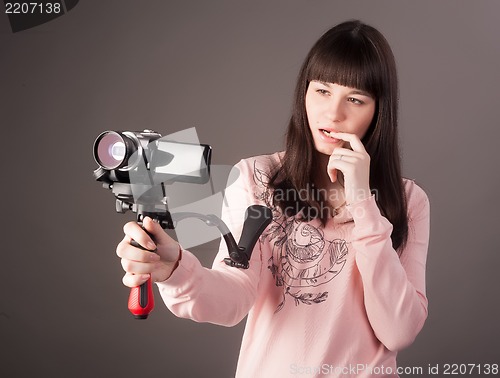 Image of young woman with video camera