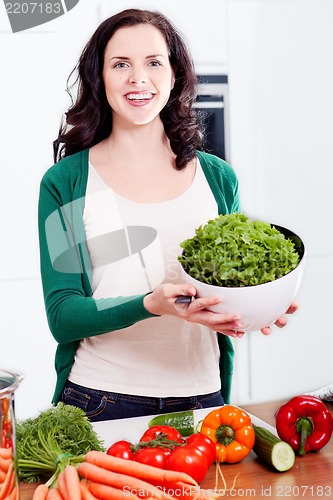 Image of young woman cooking vegetarian food