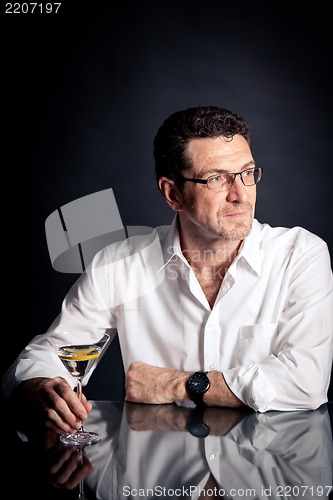 Image of adult man holding an alcoholic drink