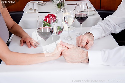 Image of happy smiling couple in restaurant celebrate