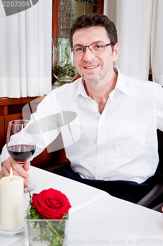 Image of couple drinking red wine in restaurant