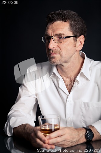 Image of adult man holding an alcoholic drink