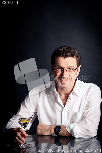 Image of adult man holding an alcoholic drink