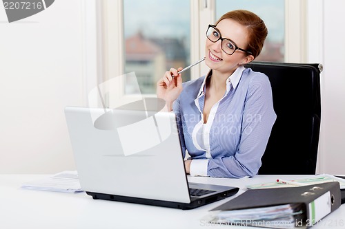 Image of young successful business woman in office