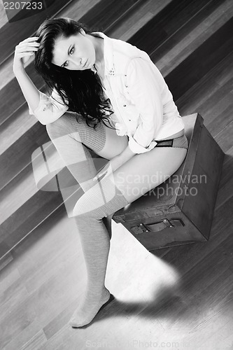 Image of attractive young woman sitting on the floor
