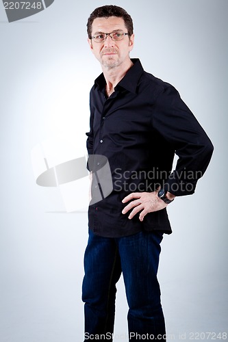 Image of attractive adult man with glasses and black shirt