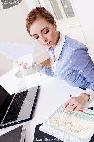 Image of young successful business woman in office