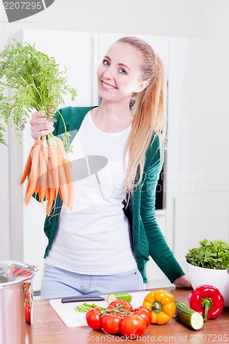 Image of young woman cooking vegetarian food