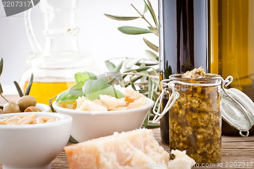 Image of tatsty geen olives parmesan and olive oil 