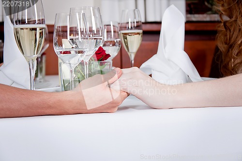 Image of happy smiling couple in restaurant celebrate
