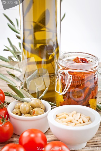 Image of tatsty geen olives tomatoes and olive oil 