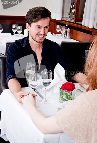Image of happy smiling couple in restaurant celebrate